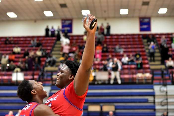 Moore's Ebi Bortey (right) celebrates after being named MVP following the Lions' win against Midwest City Carl Albert for the John Nobles Invitational title Jan. 20, 2024.